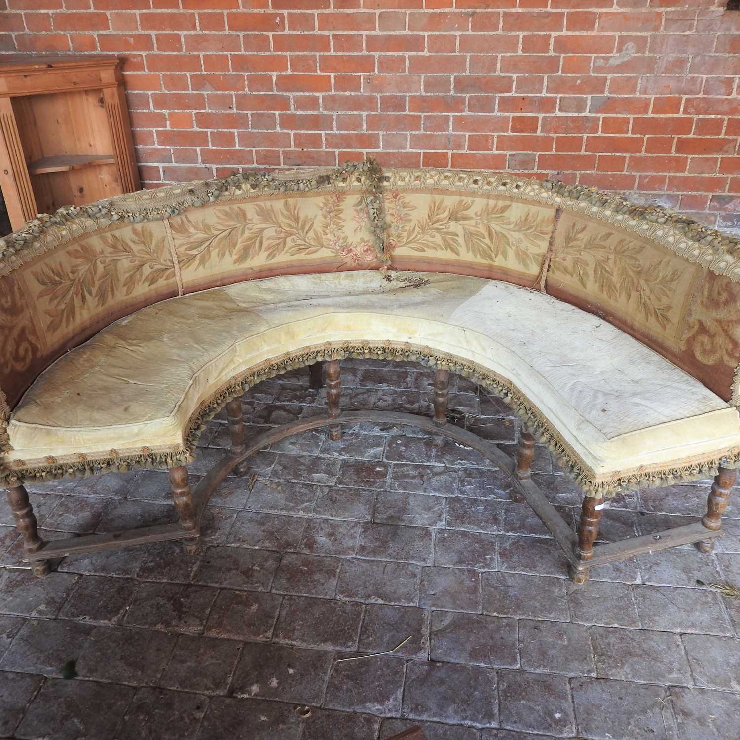 An early 20th century upholstered conversation seat