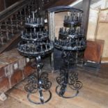 A pair of black wrought iron floor candelabra