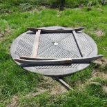 A teak folding circular garden table