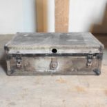 An early 20th century grey metal bound trunk
