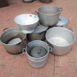 A collection of large catering cooking pots