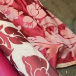 A part roll of red damask fabric