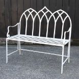 A white painted metal gothic style garden bench