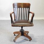 An early 20th century oak revolving desk chair