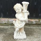 A reconstituted stone figure of a cherub