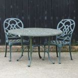 A green painted metal circular garden table