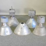 A collection of five large metal industrial ceiling lights