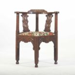 A 19th century heavily carved dark oak corner chair
