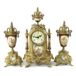 An ornate French style three piece clock garniture