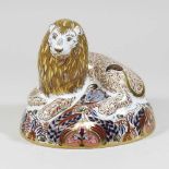 A Royal Crown Derby paperweight in the form of a recumbent lion
