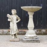 A reconstituted stone bird bath