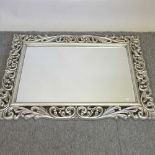 A modern ornate silver painted wall mirror