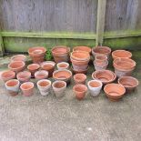 A large collection of terracotta garden pots