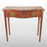 A Georgian style mahogany serpentine side table