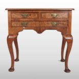 An antique walnut and crossbanded lowboy