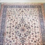 A large Persian carpet on cream ground