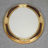 An oval shaped gilt framed wall mirror