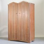 A mid 20th century limed oak double wardrobe