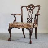 A George III style carved mahogany elbow chair