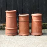 Three small terracotta chimney pots