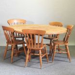 A modern pine oval extending dining table,