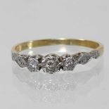 An 18 carat gold and platinum set three stone diamond ring