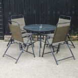 A modern garden table and four chairs