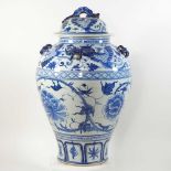 An Oriental blue and white glazed pottery ginger jar and cover