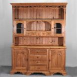 A carved pine breakfront dresser