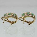 A pair of 14 carat gold emerald and diamond earrings