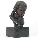 A bronze portrait bust of a girl