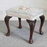 A 19th century floral tapestry upholstered footstool