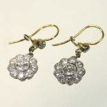 A pair of unmarked two colour diamond cluster earrings
