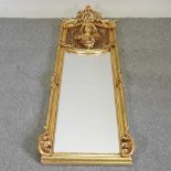 An Art Nouveau style gilt framed wall mirror