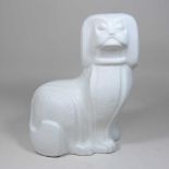 An Adler white glazed pottery model of a seated dog