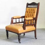 A Victorian gold leather upholstered armchair