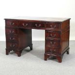 A reproduction mahogany twin pedestal desk