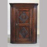 A 19th century carved oak corner cupboard