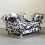 A grey crushed velvet upholstered sofa of small proportions