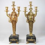 A pair of gilt metal Empire style figural candlesticks