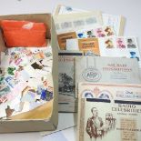 A collection of coins, stamps and postcards