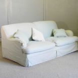 A pale green upholstered sofa