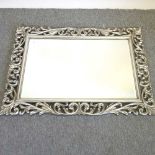 A Rococo style silver painted wall mirror