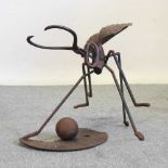 A rustic iron ant sculpture