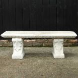 A cast stone garden bench