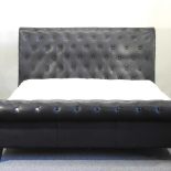 A modern black padded leather double bedstead
