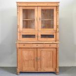 An antique pine dresser, with a glazed upper section