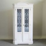 A painted pine glazed corner cabinet