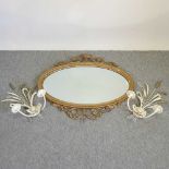 A gilt framed oval wall mirror