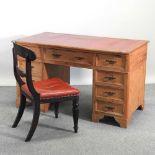 An antique pine pedestal desk